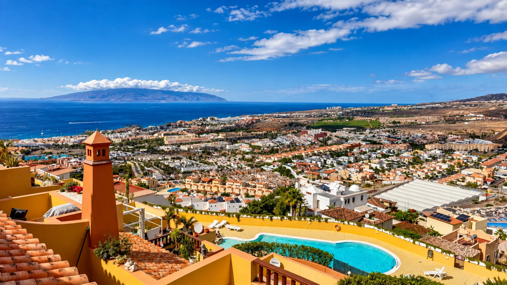 Panoramic view over Costa Adeje, Tenerife, with coastal areas, hillside homes and La Gomera in the distance