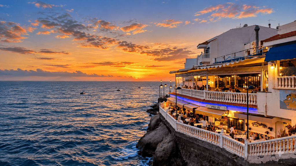 Waterfront restaurants in La Caleta, Costa Adeje, overlooking the Atlantic Ocean at sunset