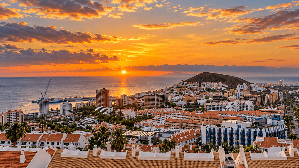 Sunset over Los Cristianos in Tenerife with the town and Atlantic Ocean in the distance