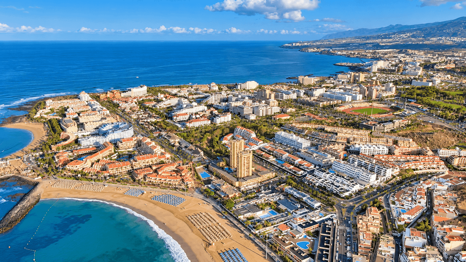 Aerial view of Playa de Las Américas in Tenerife showing the coastline, beaches, hotels and residential areas