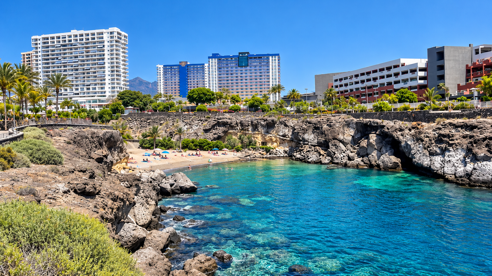 Small volcanic beach and resort buildings in Playa Paraíso, Tenerife