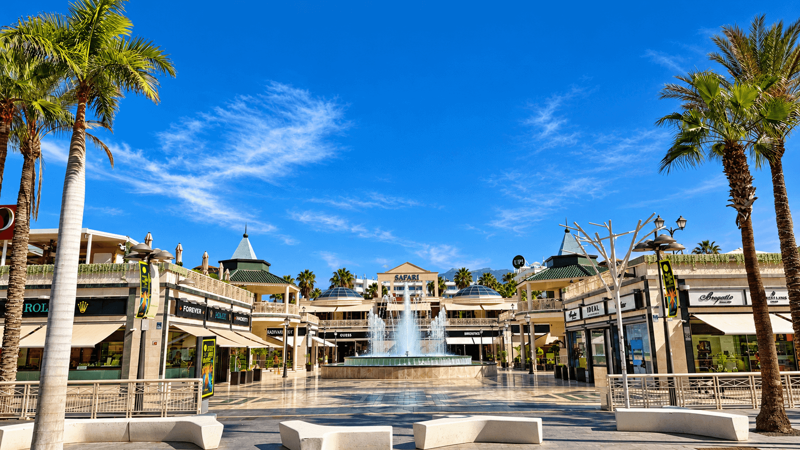 Safari Shopping Centre in Playa de Las Américas, Tenerife with palm trees, shops and central fountain